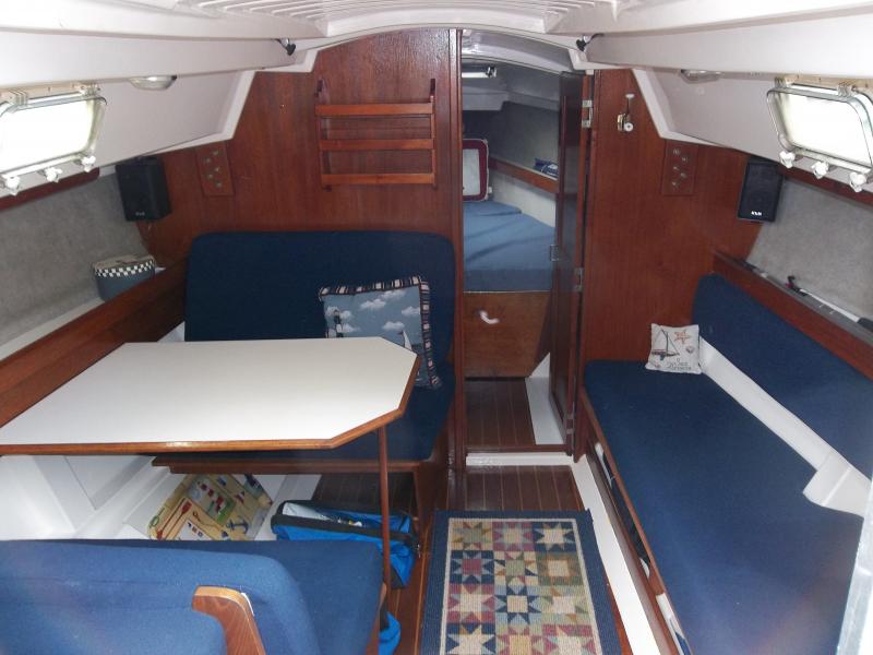 Salon &amp; v-berth, 4 opening ports w/screens, table converts to bed, refinished woodwork, starboard settee w/storage below