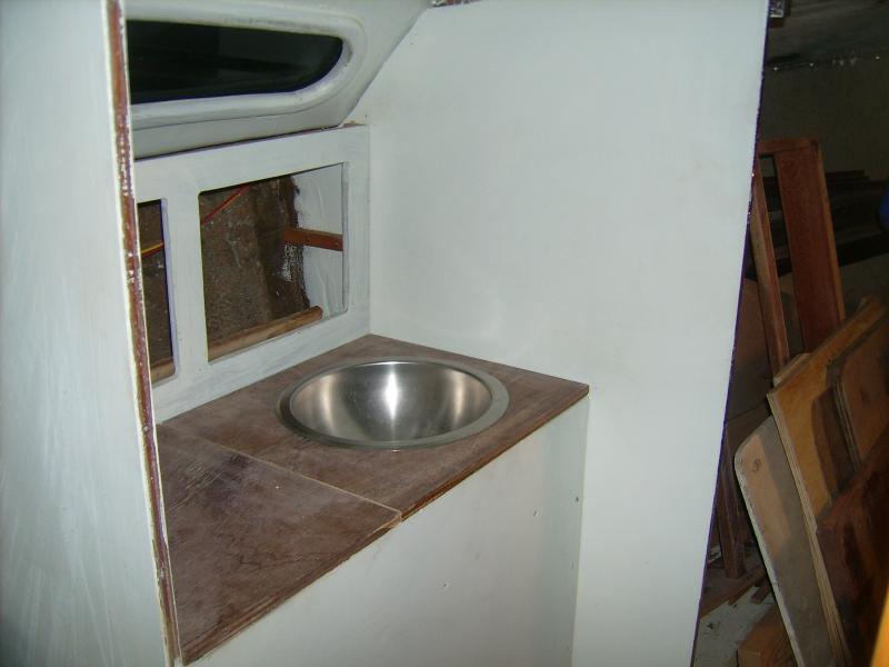 September 2011.  These are the parts to the head sink which I mocked up for this photo.  The nearer section of the countertop (aft) lifts up for access to the 4&quot;-deep bin above the berth footwell.  The two lockers outboard are mirrored on the other side, though being above the toilet they are taller and therefore bigger.