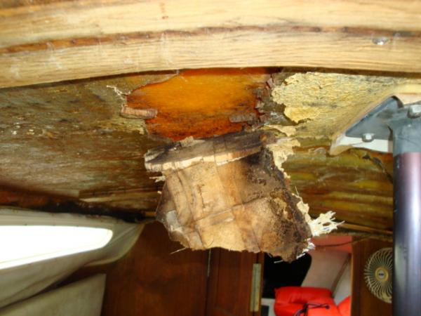 serious water damage in the ceiling glassed over wood... I think it leaked in at the mast support?????