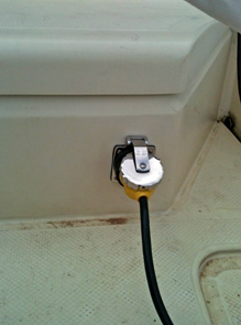 Shore power connection into starboard locker. (Dirt in cockpit is optional.)