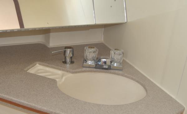 Shows installation of hand soap dispenser.  Avoids chasing the bar soap around the cabin when under sail.