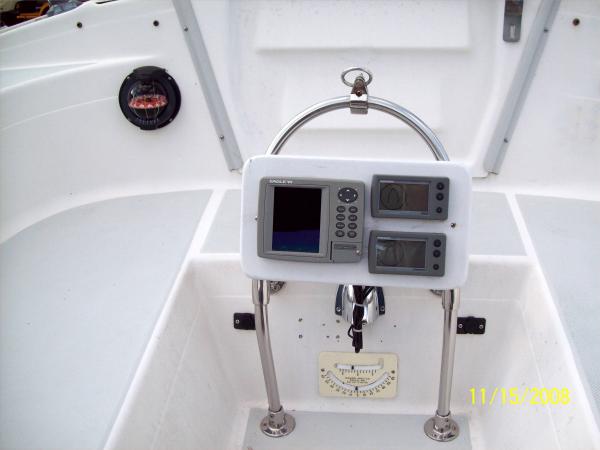 SS Instrument Arch, Compass, Inclinometer and 2-12V outlets.  SS ring holds main sheet rigging.  Instruments easily read/reached.  Mainsheet out of companionway.  Best Mod we've done!