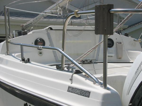 Stern rail with mount for dinghy outboard.