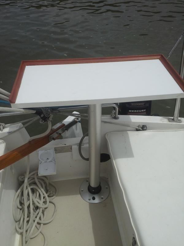 The cockpit table built out of a piece of utility shelving and mounted on a marine grill stand that screws into the basse fitting for easy mounting and removal. Great for cooking on then as a cocktail table. It all fits down below in our new custome shelves.