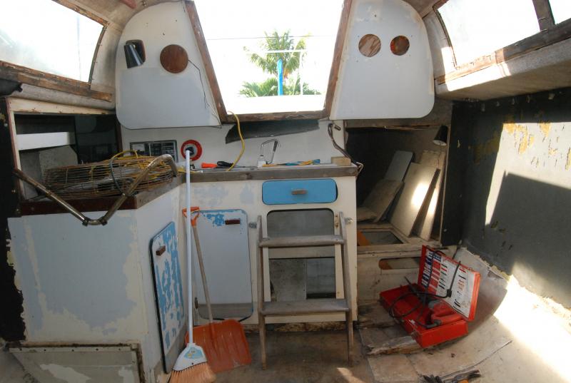 The galley base was solid so its staying. The counter top needs replacing though. If you look close at the base, you can see a gray line about 8 inches from the bottom. At some point it had standing water in it.