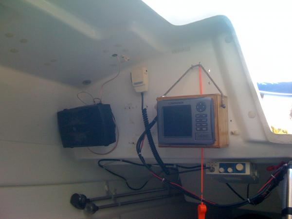 The Lowrance HDS-5 stays here when it's not in use.
 The vhs underneath it was put there by the PO. Eventually I plan on upgrading. When I do, it'll probably go over the galley.
  The speakers, have extra wire, so I can mount them out on the deck. It really sounds good with them out there!
  The orange whistle is legal, I think, but is getting replaced soon too.