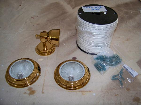 The main components of my new cabin lights. I used boat cable, brass tone lights, and marine grade heat shrink connectors. I could not afford the LED, but hope to upgrade lamp by lamp as time goes by.