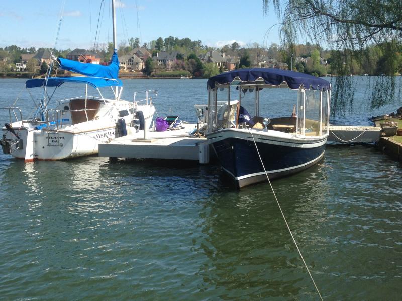 The MerMade at my mini marina on Lake Windward next to my Duffy 21' Old Bay electric boat.