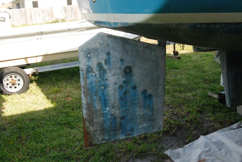 The rudder was in bad shape. Completely saturated with water. You can see were some previous owner drilled random holes to drain. Their patch job eventually leaked as well. I dug a hole in the ground and dropped the rudder out to work on in the garage. I sanded down to the gelcoat and drilled 5/16 holes every 3x3 inches. Then i let the core dry out for about 2 months, refilled with penetrating epoxy. Put 4 cotes of barrier paint back on and bottom painted.