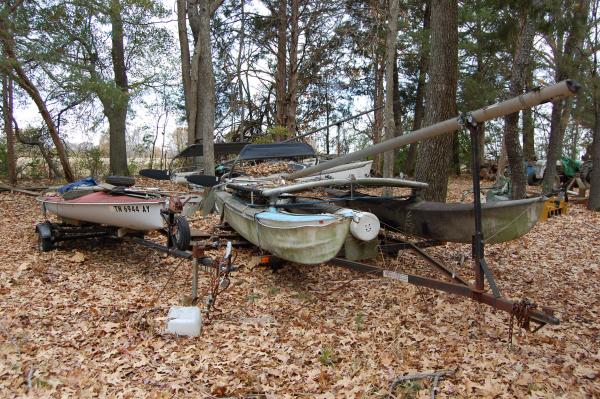 The sidewinder and hobie 16 and hobie 17 parked 
under the trees. I gotta finish that boat barn.