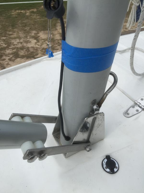 The system uses a SS double ended stud to secure the mast. Once the must is up, the gin pole winch keeps it in place freeing both hands to secure the fore stay.