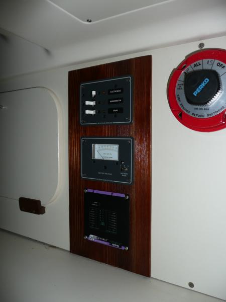 This is in the center of the wall aft of the bunk area. It's circuit breakers, a three channel volt meter and the display panel for the charger. One of the circuit breaker shows “refrigeration”.  A failed attempt at a refrigeration system. Decided it would draw to much precious energy and took it out.