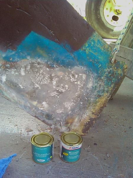 This is when growing up repairing your own surfboards pays off. All together it took 4 layers of glass mat and resin that was sanded way back after every application to get a good smooth finish. This picture was the second application. Put the cans in for size reference.