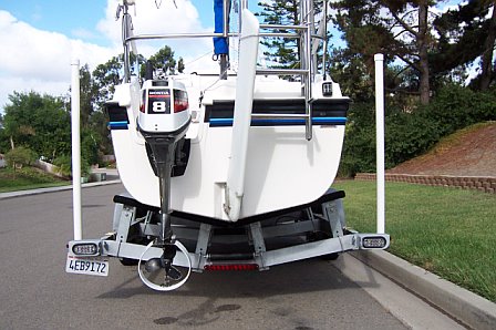 Trailer goes almost all the way to the transom.  No need to put support, such as jack stands under the rear of the trailer while not hitched to the tow vehicle.
