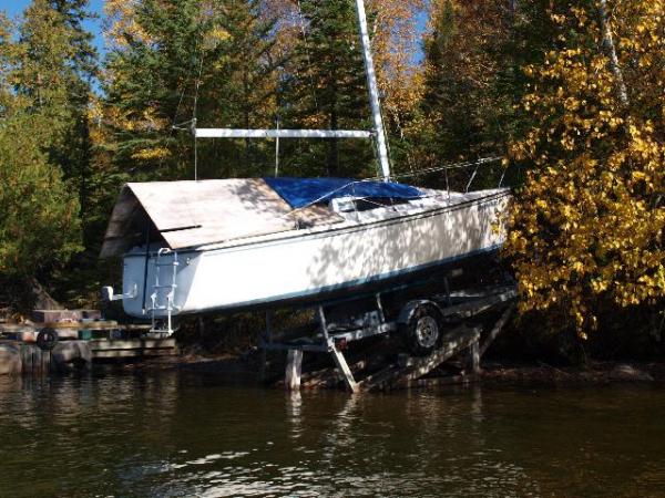 trailer; I made the ramp with timbers bolted to rock with anchors. I have a small metal wheel near the trailer tongue that I can &quot;steer&quot; up a center ramp board. I use the trailer winch to haul out, and a small come-along to pull the boat onto the trailer.