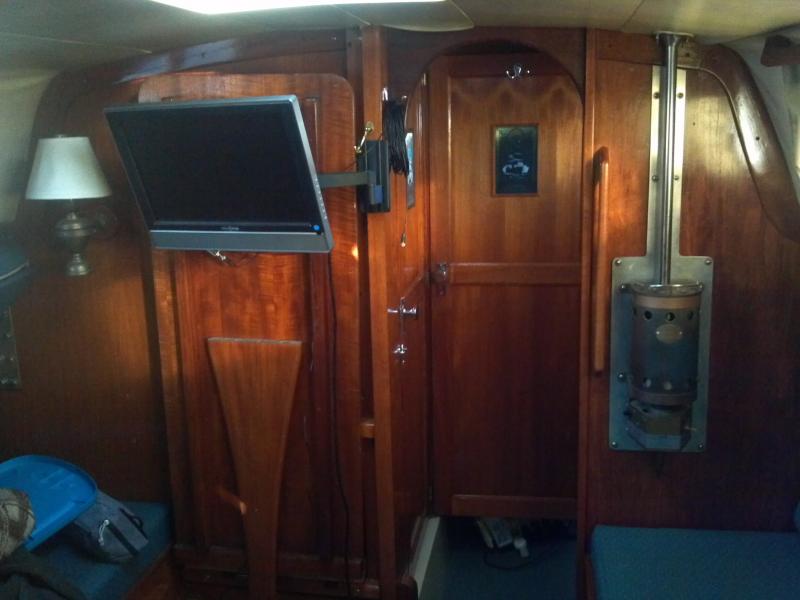 tv mounted on swing bracket, so it can be watched from the v-berth.. dvd is mounted behind the table, so table must be down in the table position or the berth position to watch a movie.
I like the privacy that the door offers to the V-berth.