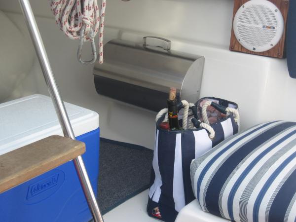 We installed a stereo system and built mounting cabinets to fit inside the liner.  The stainless steel storage bin is a bread box from IKEA that is mounted to the wall.  We used velcro to hold the lid closed.  This provides storage for our pots and pans. We placed beach bags, velcroed in place. They  provide storage and a nice bag to go ashore with if needed.