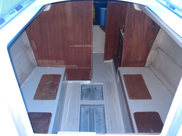 When I bought her there was standing water on the cabin sole which rotted the bottom of the port bulkhead and the compression post. The starboard bulkhead was rotted where the water dripped down the chainplate from the deck. The fabric on the hull is stained and the glue is dried and coming apart. The teak and holly floorboards covering the bilge were also rotten and will have to be replaced.