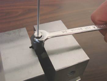 Compression fitting assembly using a pre-swage tool in a vise 